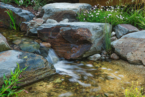 Image of beautiful mini waterfall in garden stream.